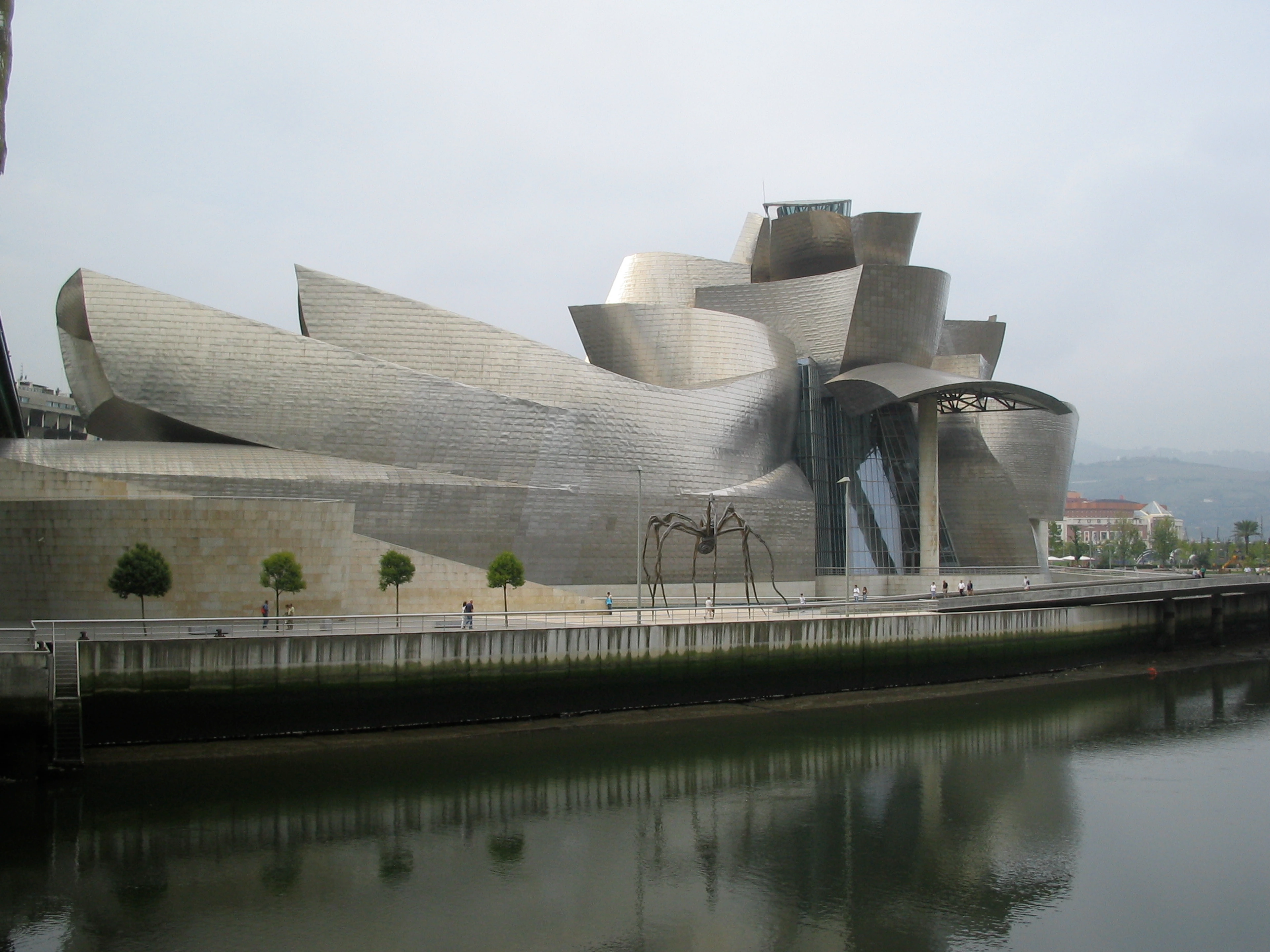 Guggenheim Museum Bilbao exterior with spider sculpture and river reflection