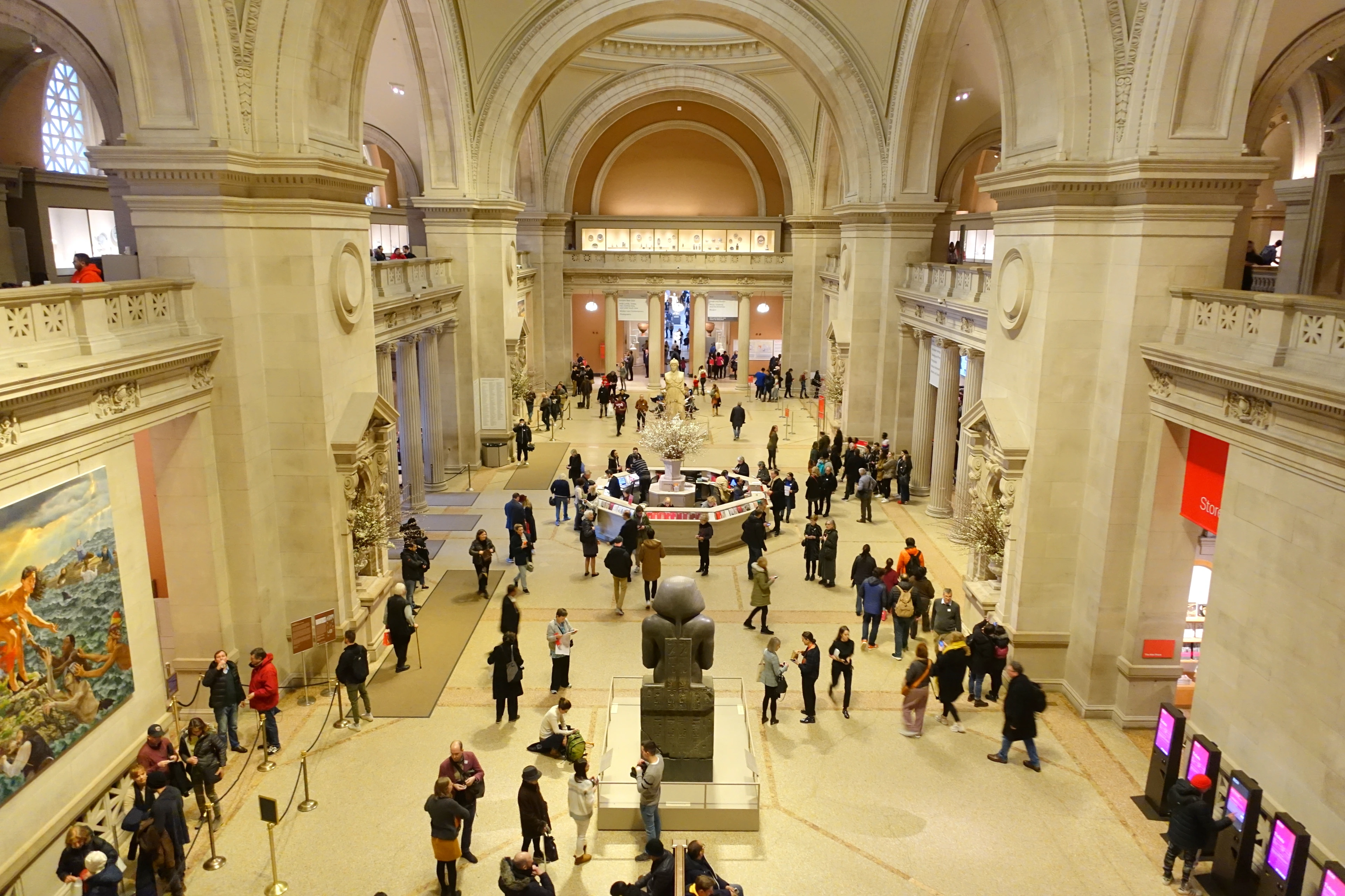 Interior view of the Great Hall at the Metropolitan Museum of Art in New York City, showcasing its grand architecture and visitors.