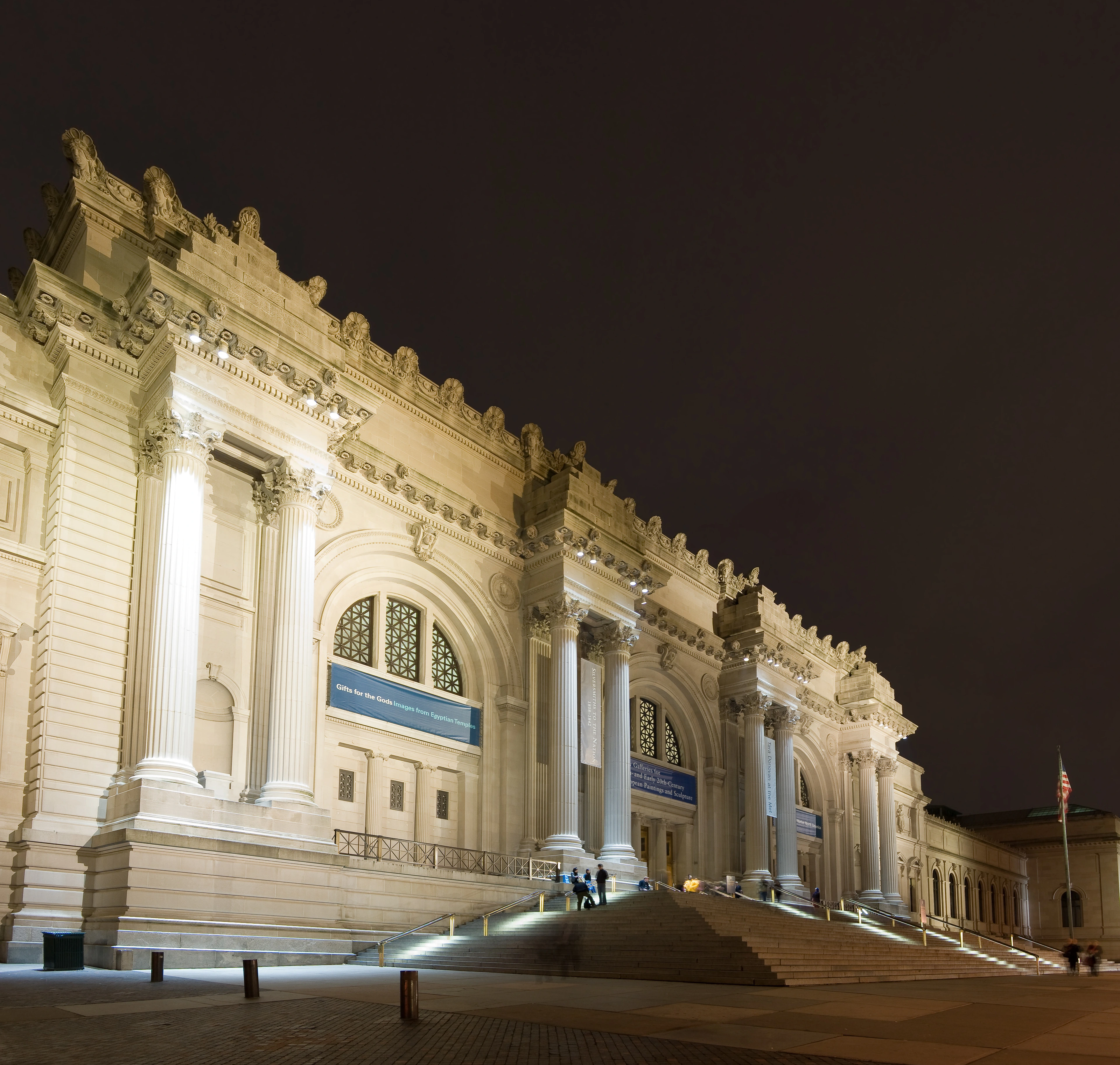 The grand neoclassical facade of The Metropolitan Museum of Art in New York City, demonstrating monumental scale and public presence.