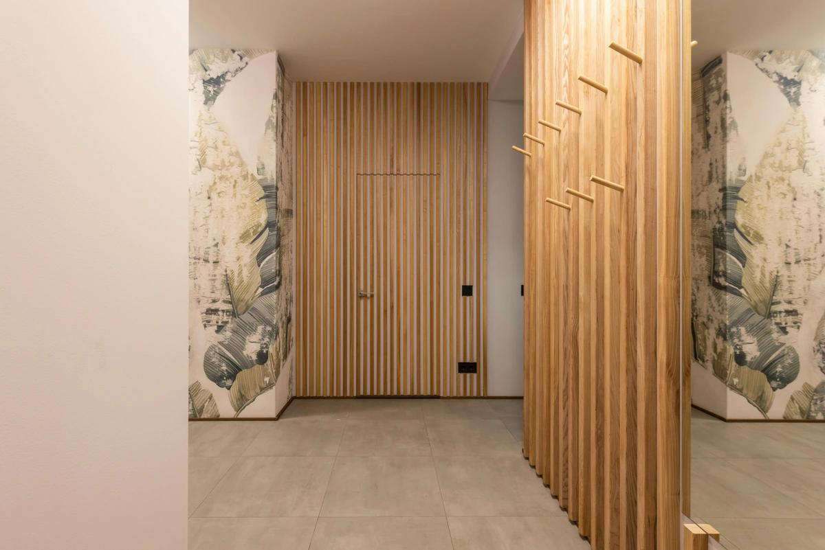 Modern living space with wooden panel dividers and abstract art wallpaper