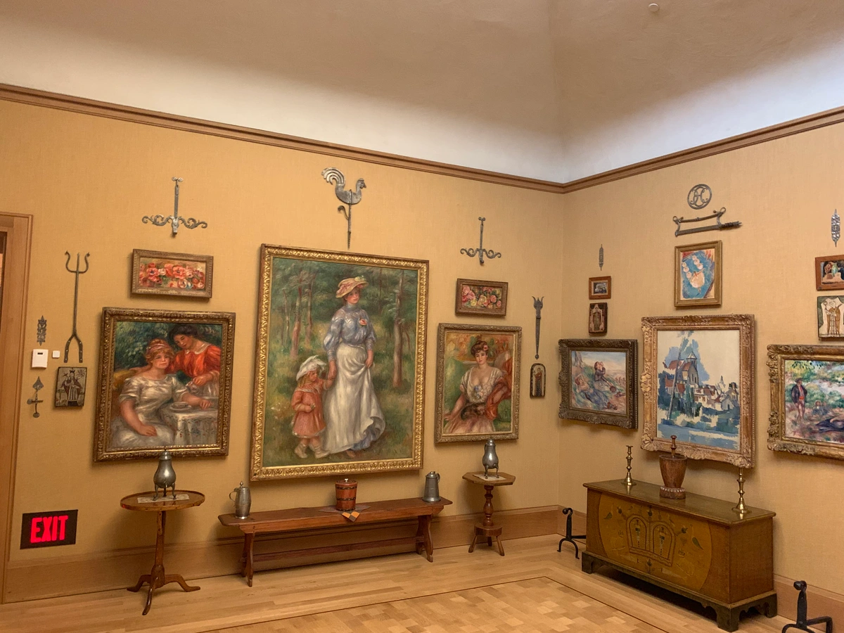 Interior view of the Barnes Foundation gallery with paintings and decorative elements.