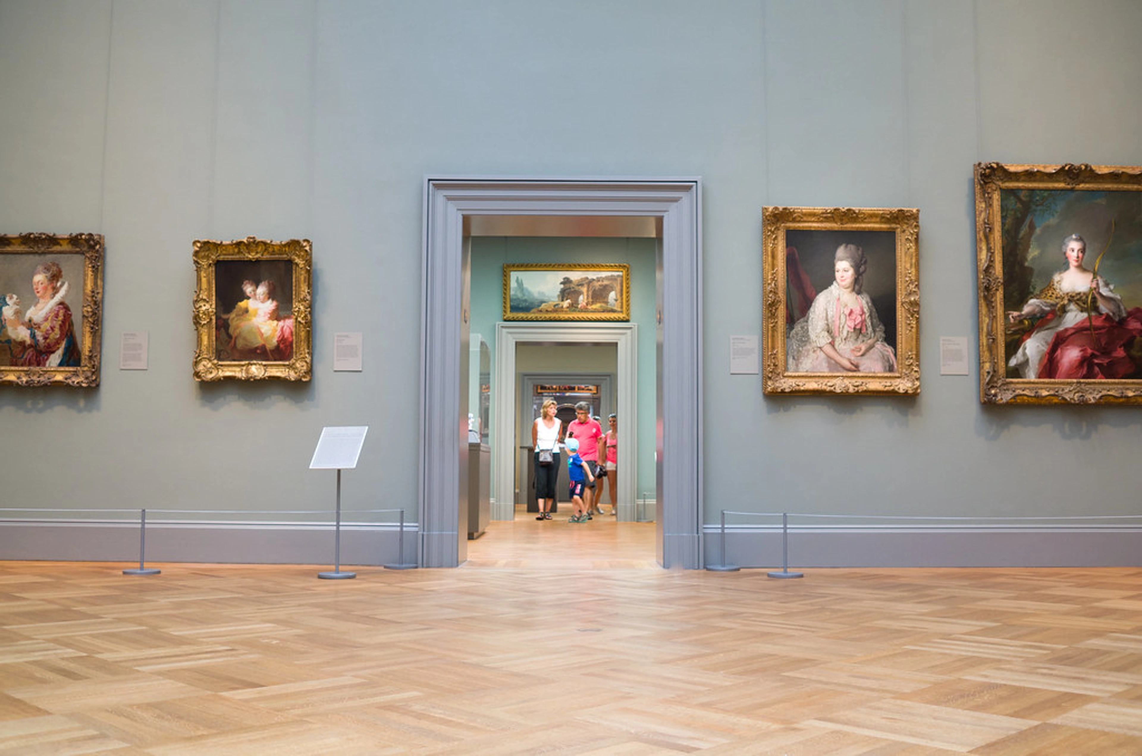 Visitors admire European paintings in a gallery at The Metropolitan Museum of Art, New York.