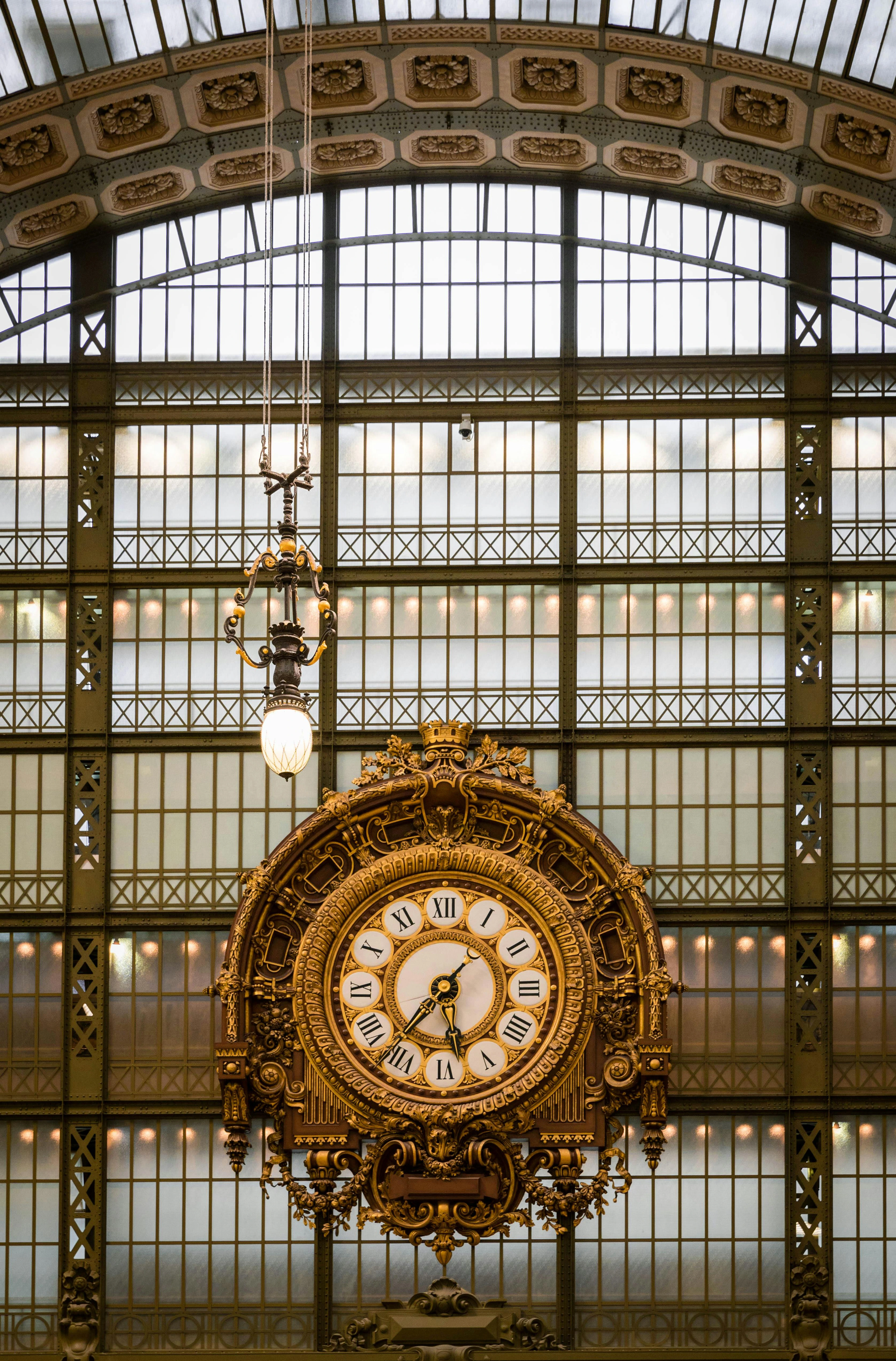 The iconic golden clock at the Musée d'Orsay in Paris, a prominent feature of the museum's interior architecture.