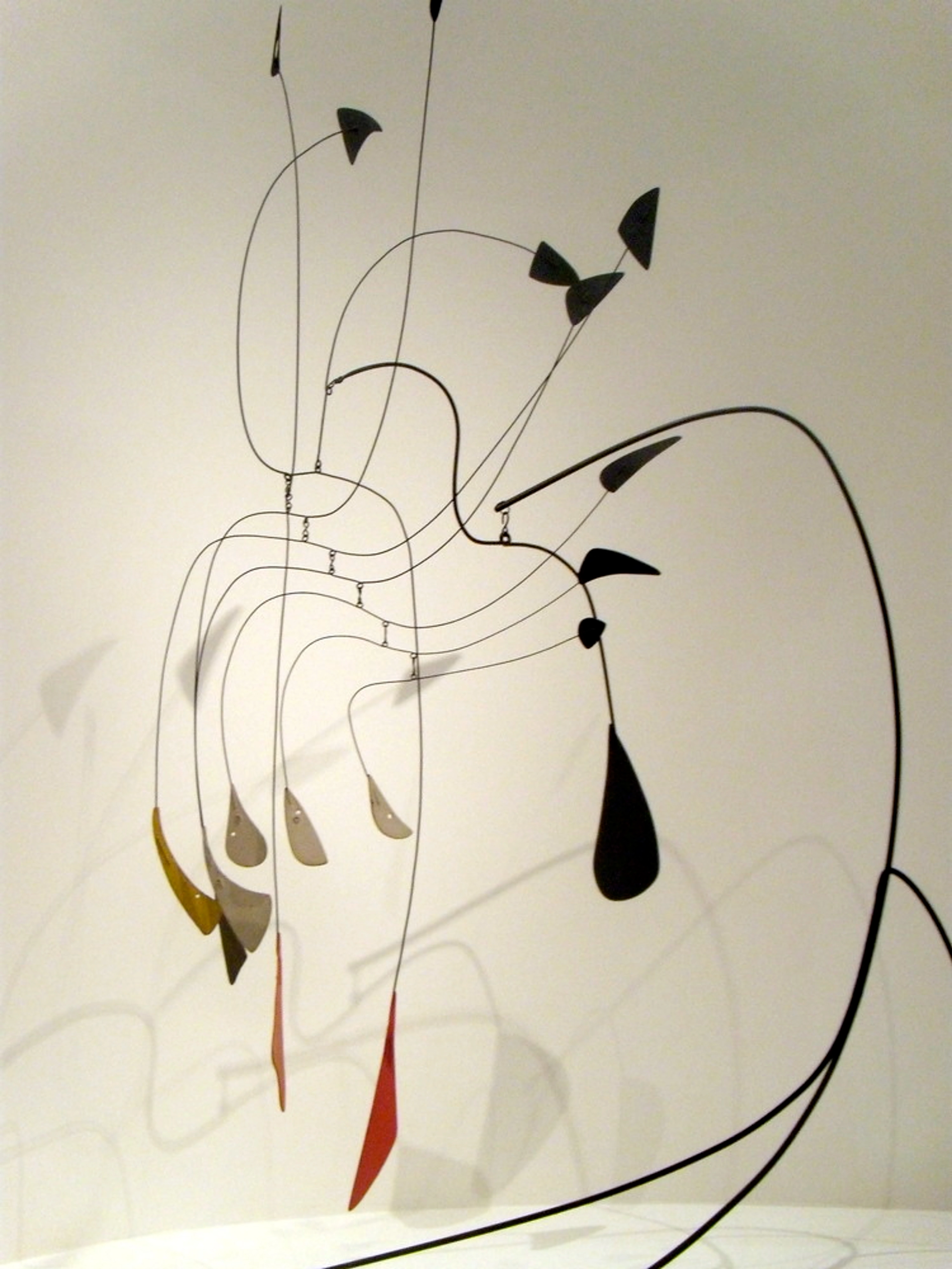 Abstract Alexander Calder metal mobile sculpture, suspended painted sheet metal and wireframe shapes in geometric and organic forms.