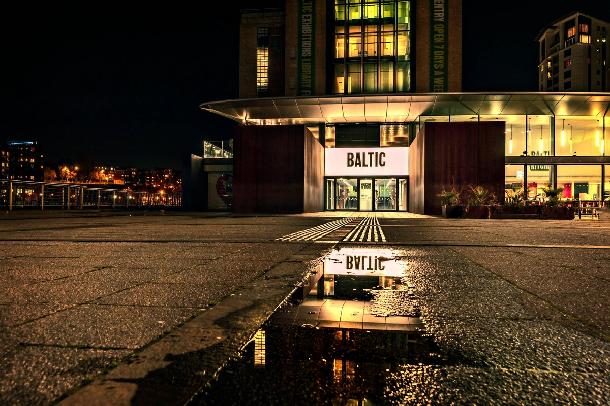 Baltic Centre for Contemporary Art facade illuminated at night against dark sky