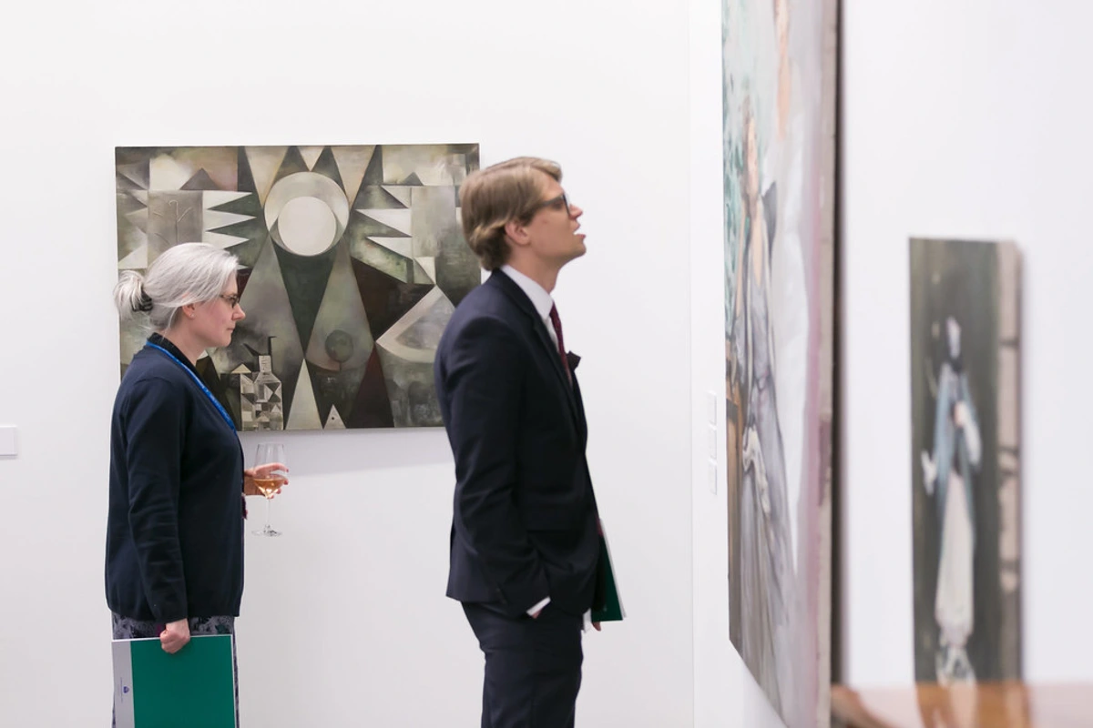 People viewing contemporary art at the ECB Vernissage exhibition in Poland.