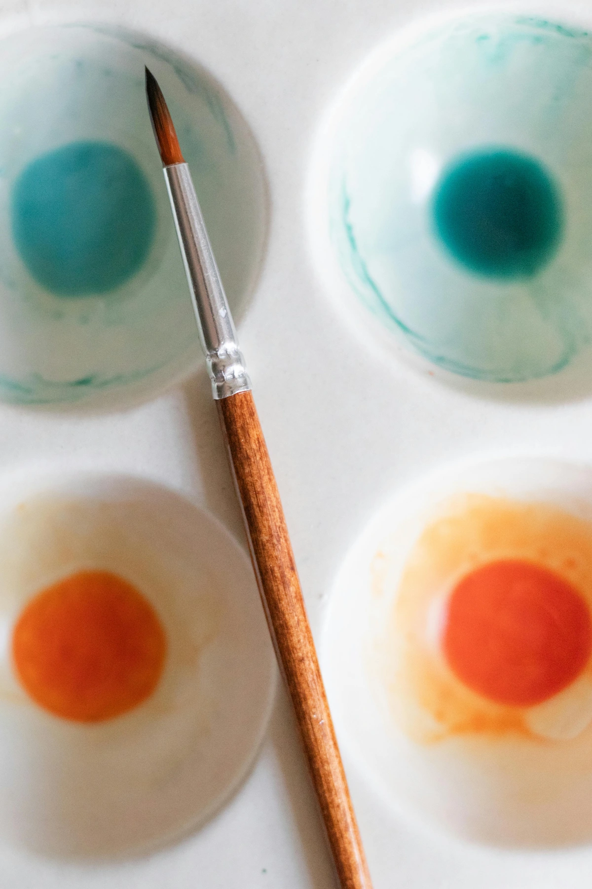 Paintbrush on Paint Bowls - Free Stock Photo for Art Tutorials and Color Mixing Guides