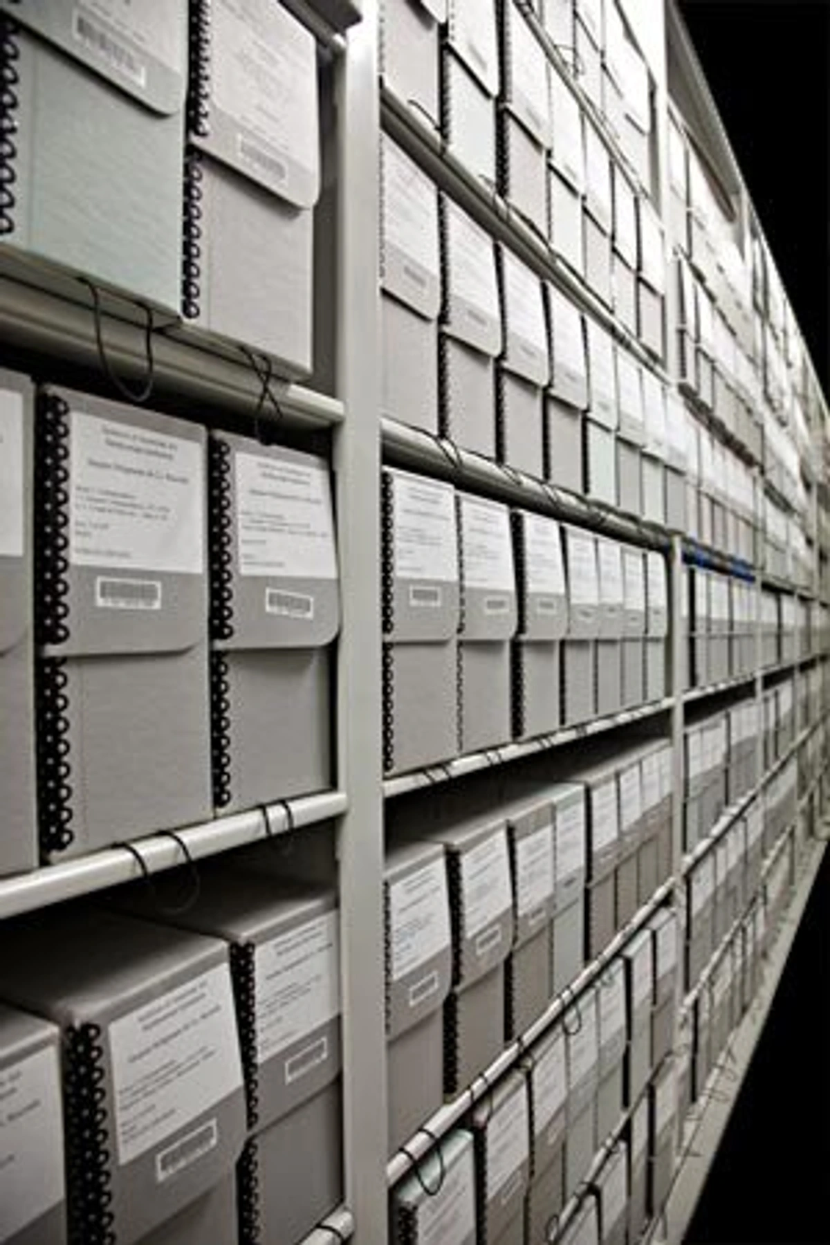 Art storage solutions for collectors: Rows of archival boxes on shelves in a museum or archive.