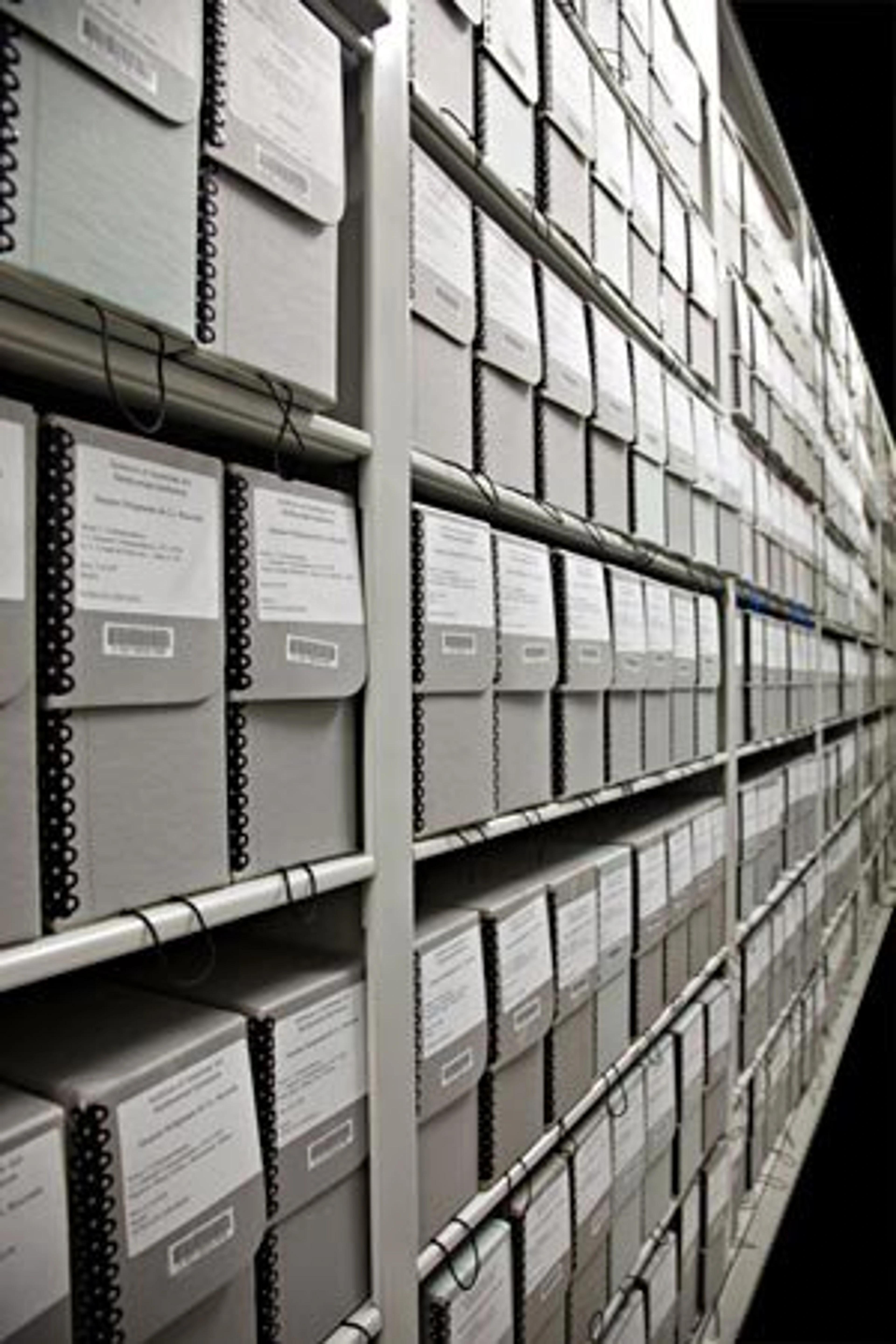 Art storage solutions for collectors: Rows of archival boxes on shelves in a museum or archive.