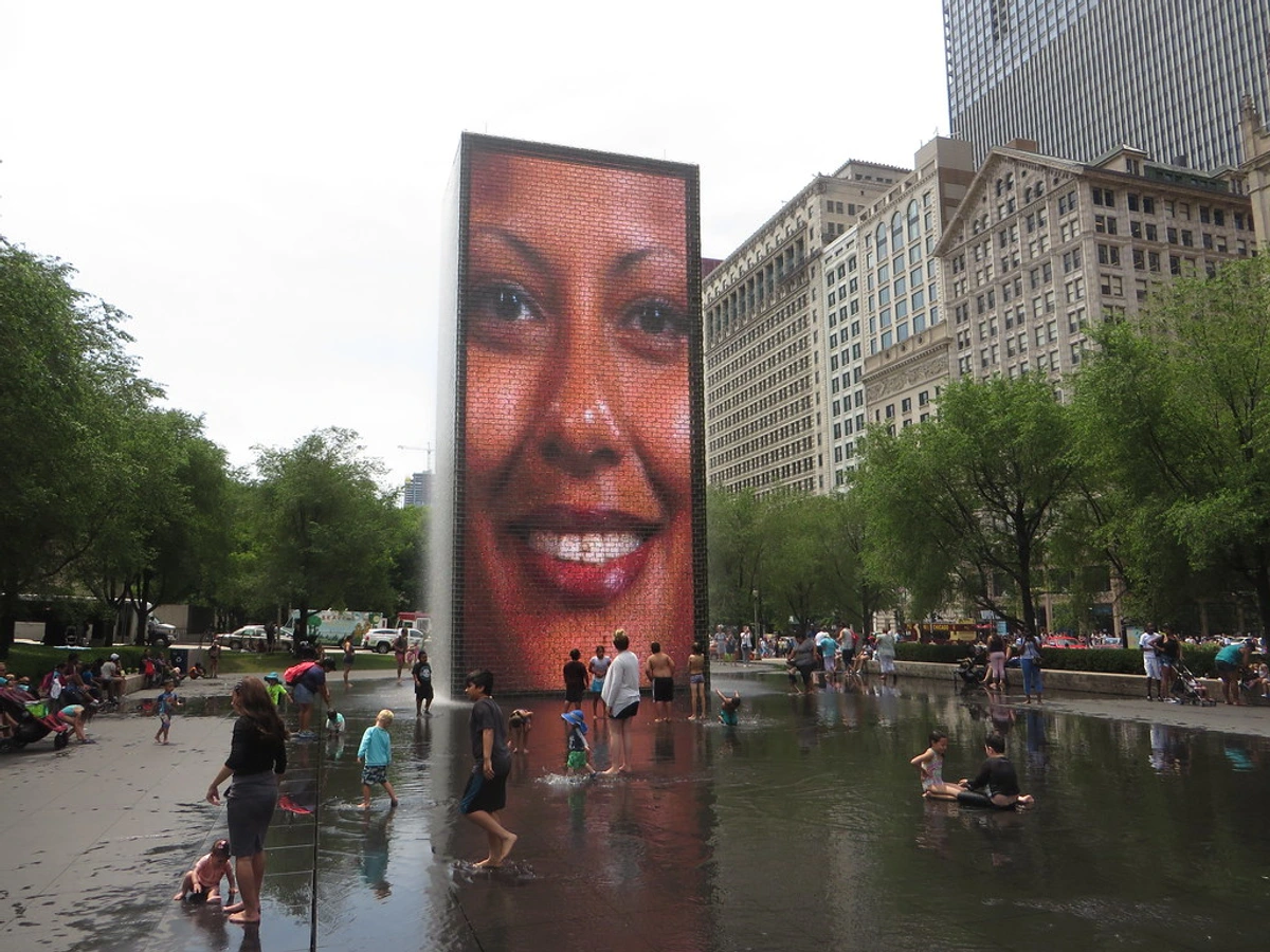 Interactive Crown Fountain at Millennium Park, Chicago, with smiling digital display attracting visitors