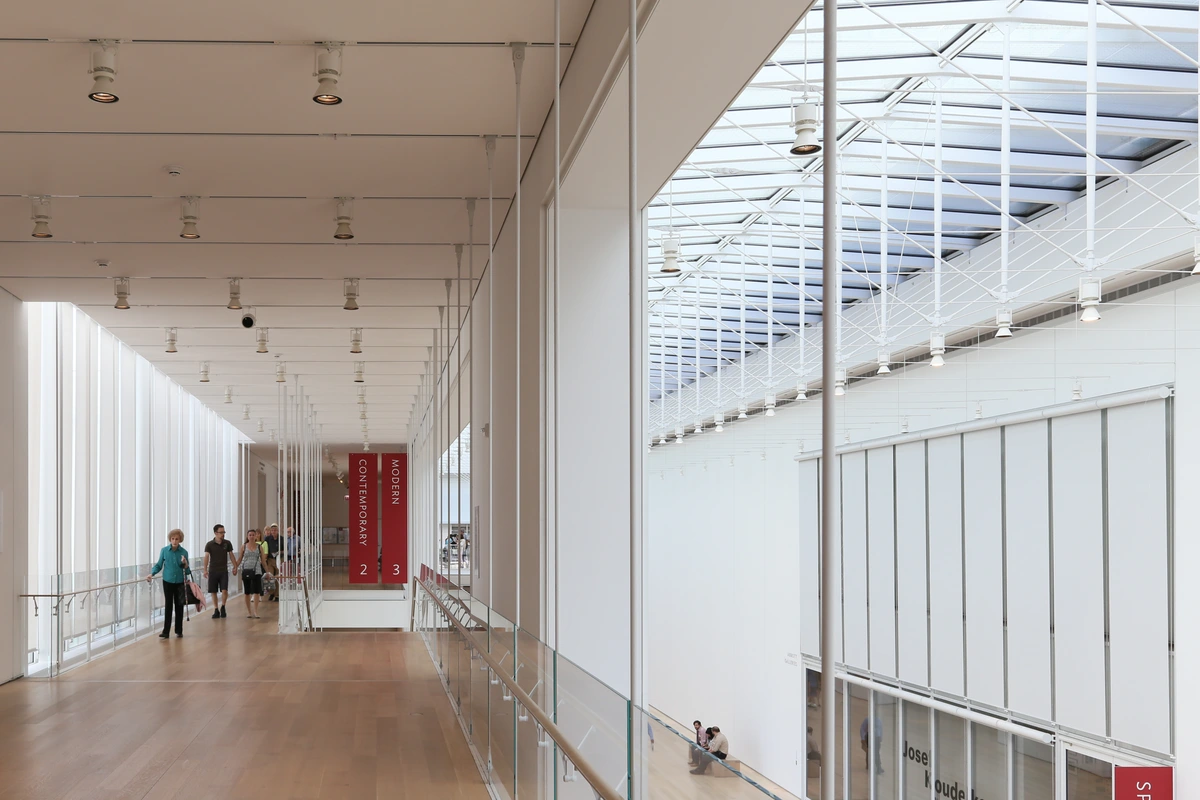 Interior view of the Modern Wing's second level at the Art Institute of Chicago, showcasing its architecture, galleries, and visitors.