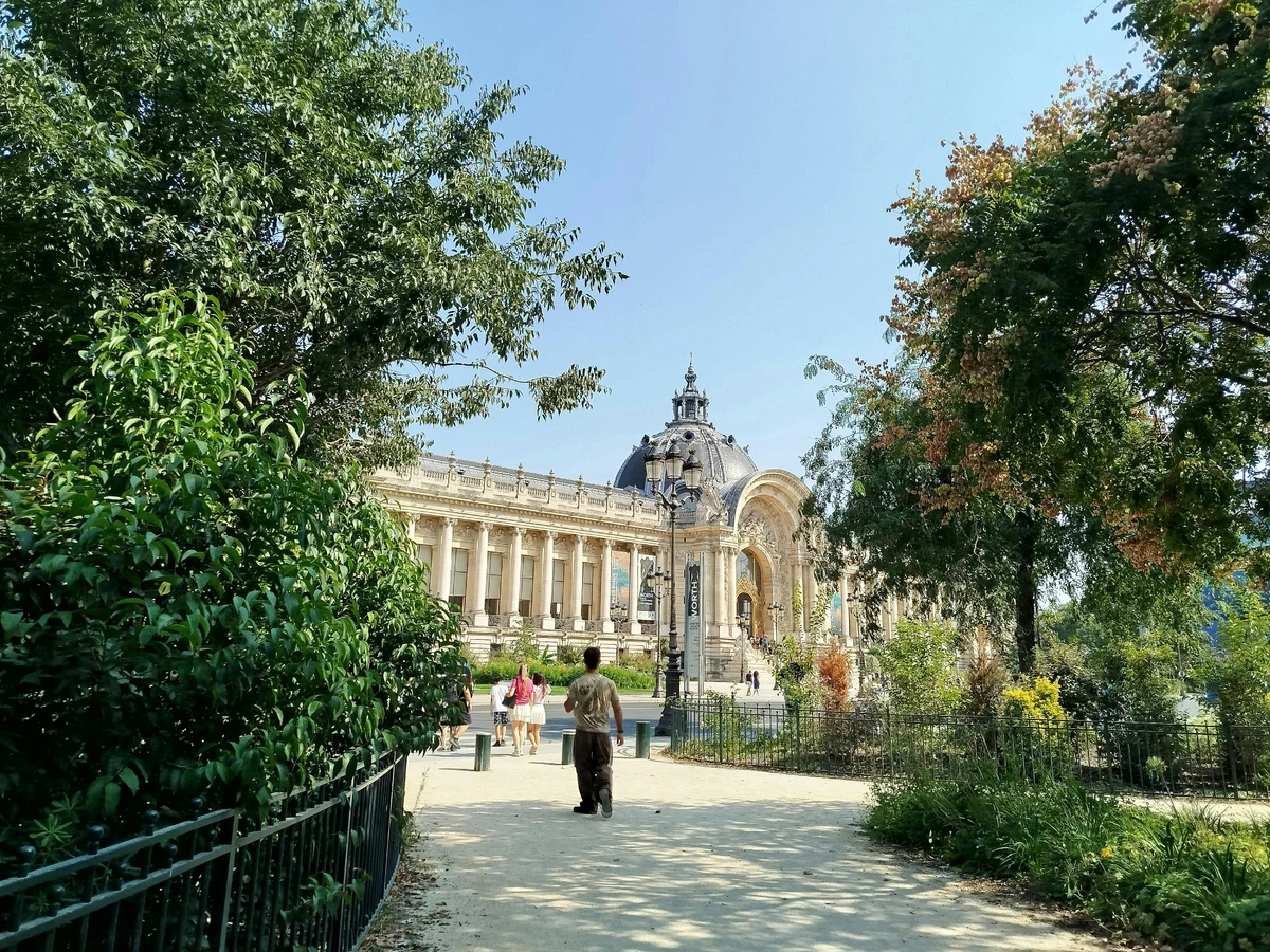 Visitors exploring Petit Palais gardens in Paris, France