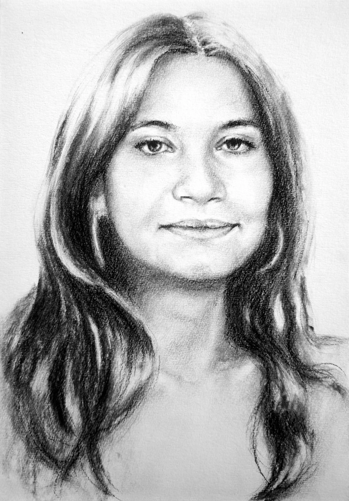 Charcoal portrait drawing of a woman with long, flowing hair.