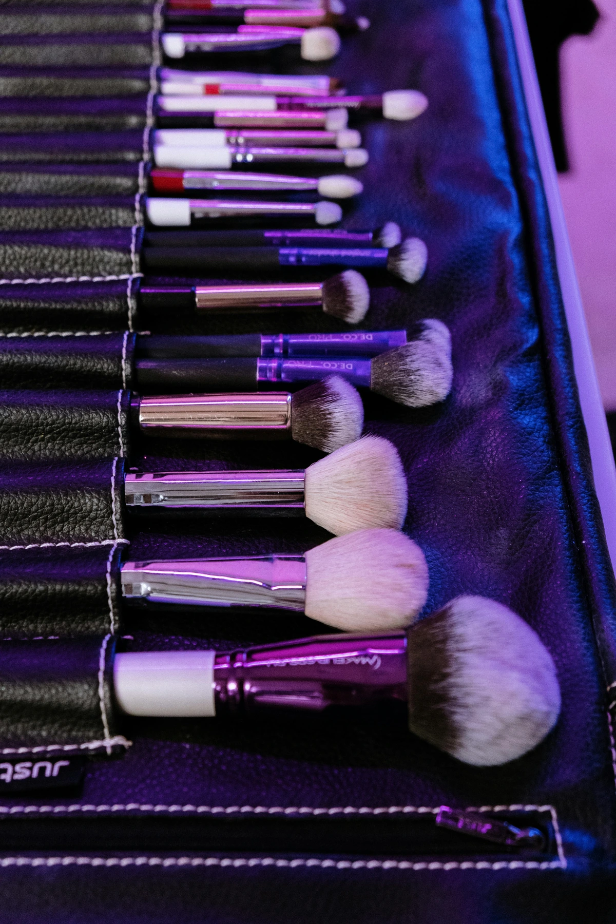 black and silver makeup brush set displayed on leather case, professional cosmetics tools collection for beauty artists