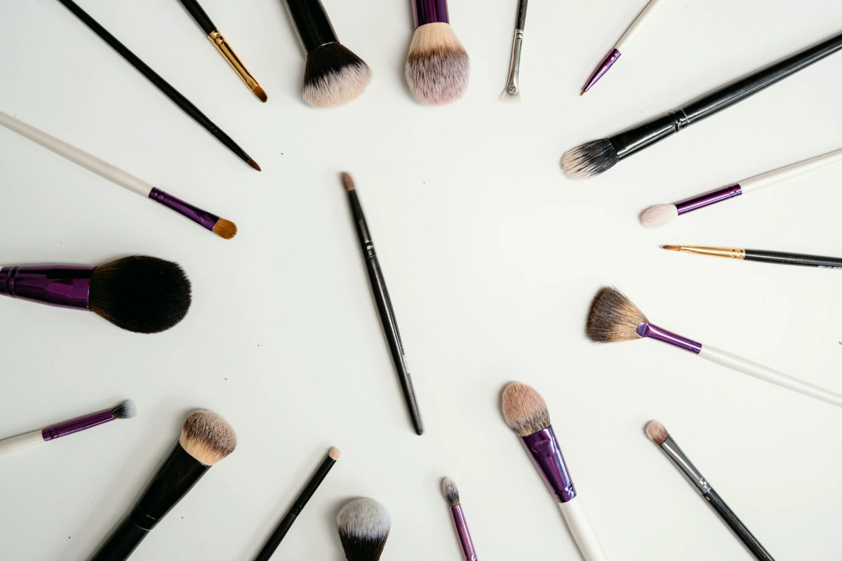 Top-view arrangement of synthetic makeup brushes ideal for product reviews and beauty tutorials.