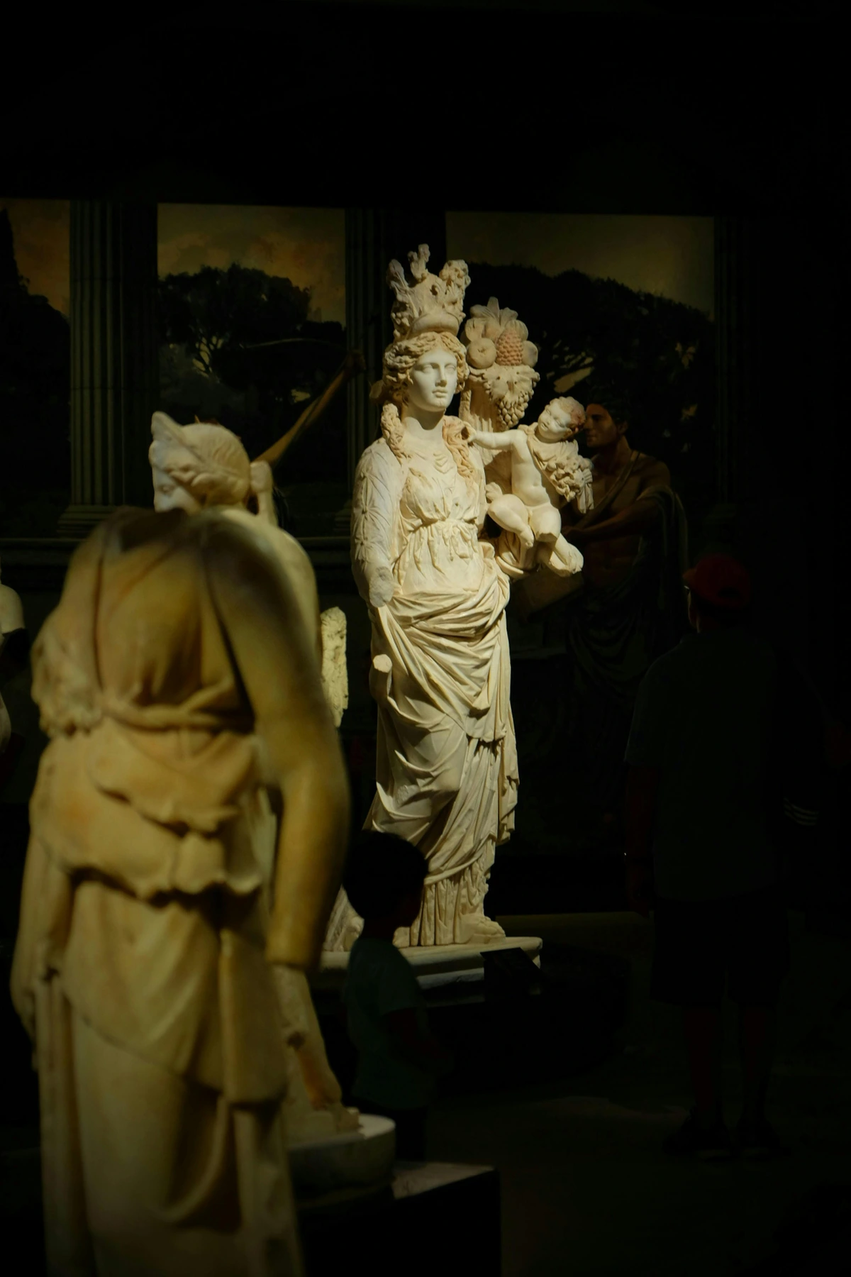 Renaissance sculptures displayed in a museum setting, showcasing classical art with intricate stonework and fabric details