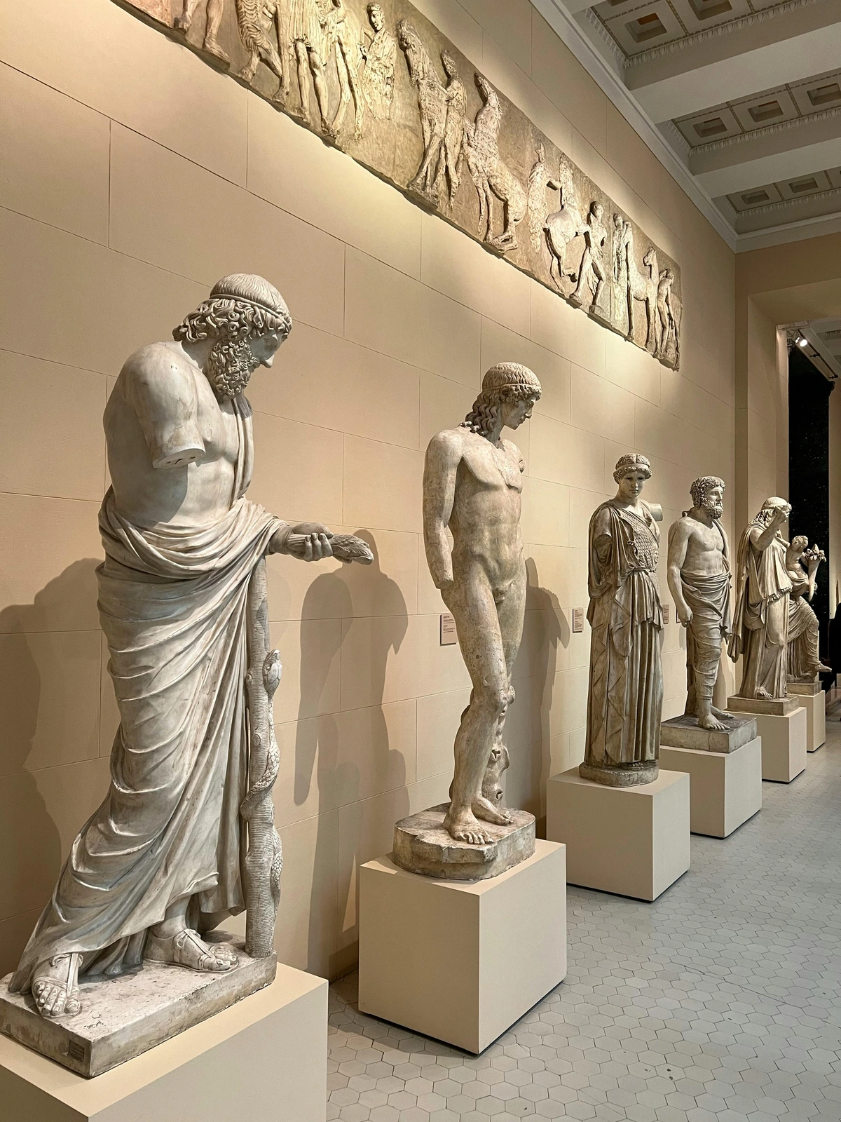 Ancient marble statues in a museum setting, showcasing timeless art with lasting appeal.