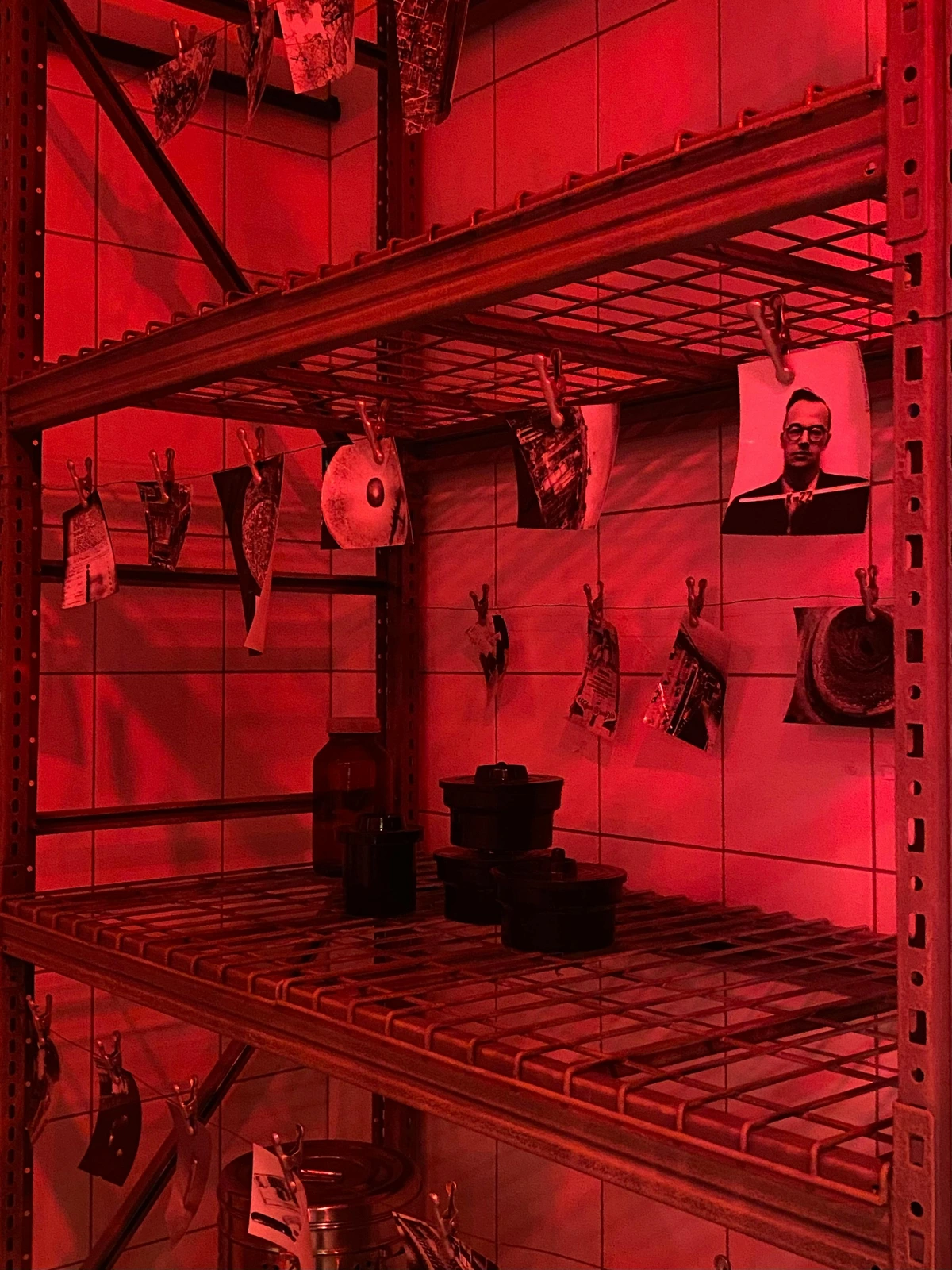 Art buying guide showing film photos displayed on darkroom shelves for photography enthusiasts