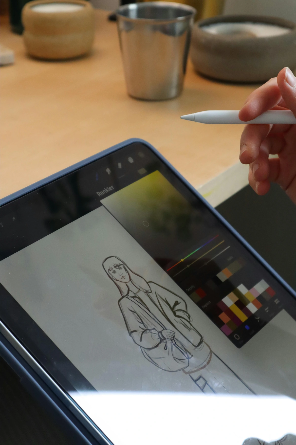 digital illustration of girl using stylus on tablet sketching jacket design