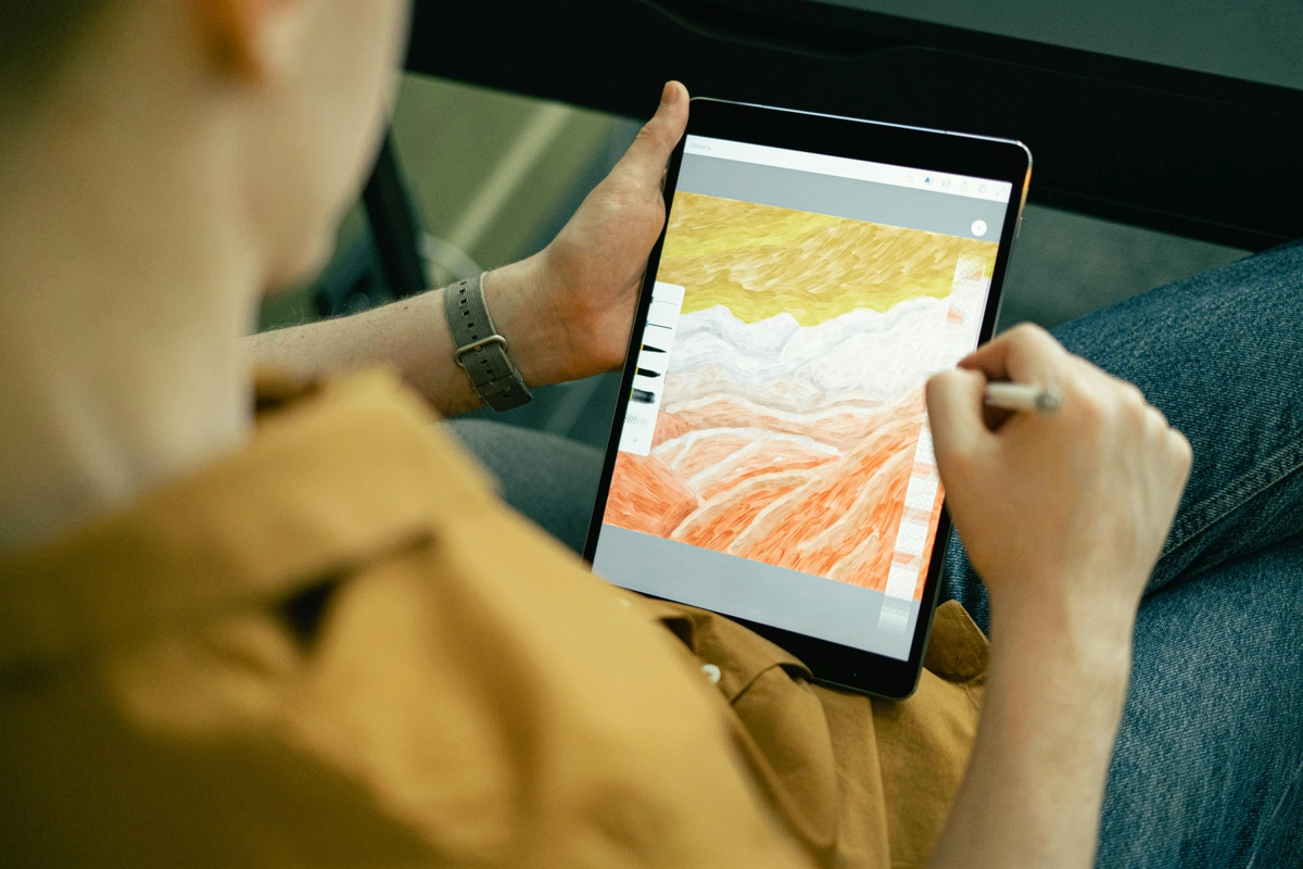 Person drawing abstract galaxy design on tablet with technical mastery in digital art.