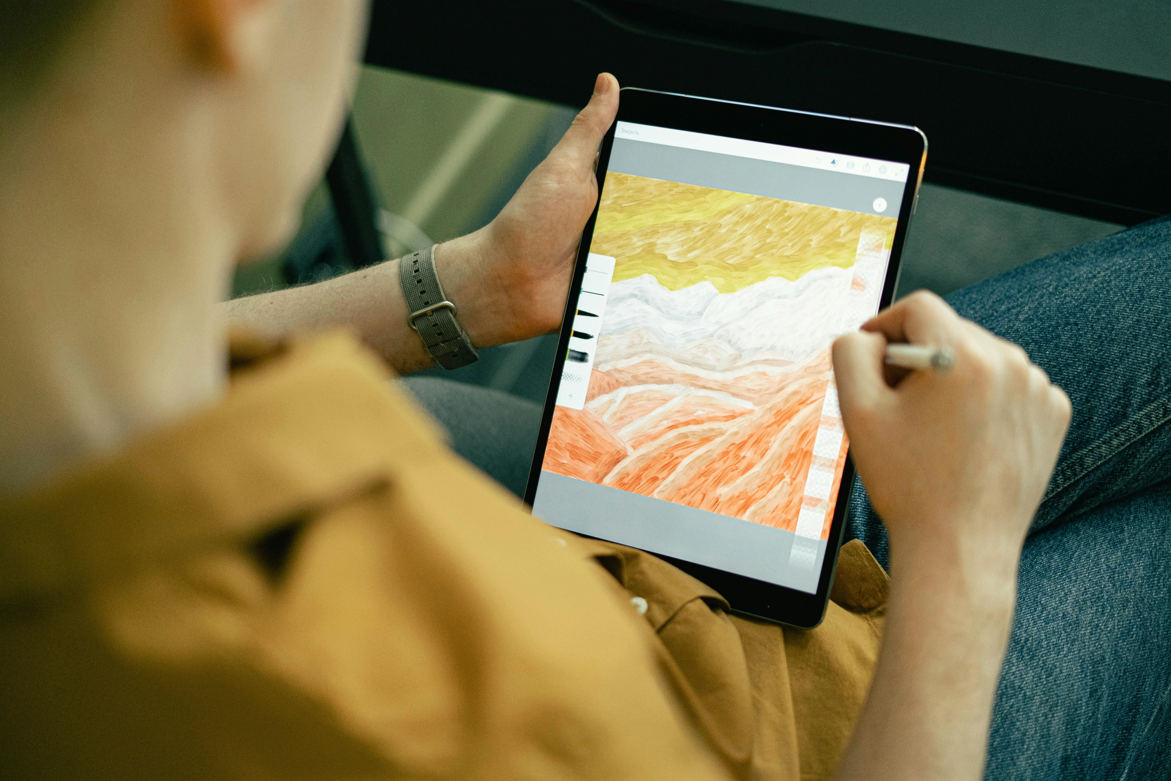 Person drawing abstract galaxy design on tablet with technical mastery in digital art.
