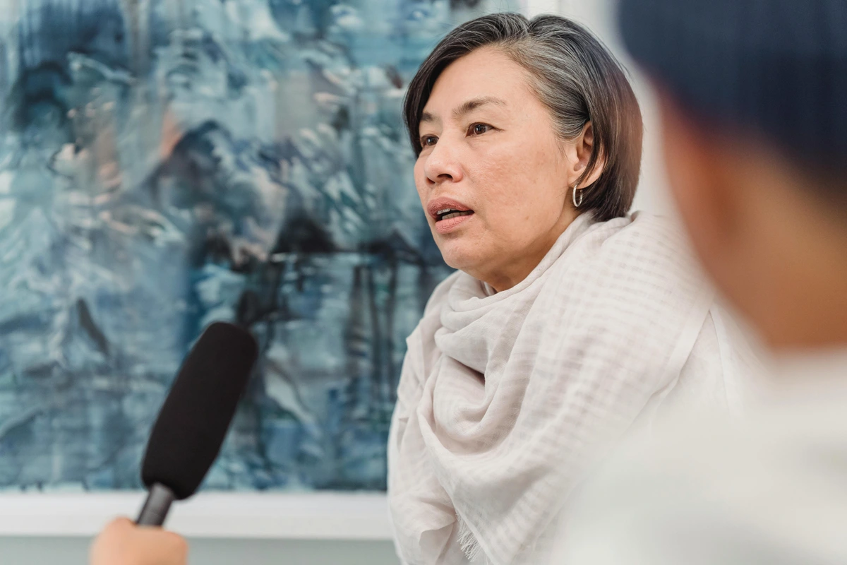 A-Woman-Being-Interviewed-in-Art-Gallery