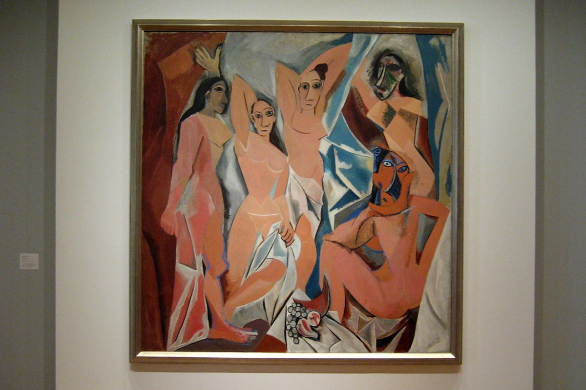 NYC's Museum of Modern Art showcases Picasso's Les Demoiselles d'Avignon, a seminal Cubist painting featuring fragmented figures and bold primitivism influence. A museum-quality photograph captures the iconic 20th-century masterpiece in its gallery setting.