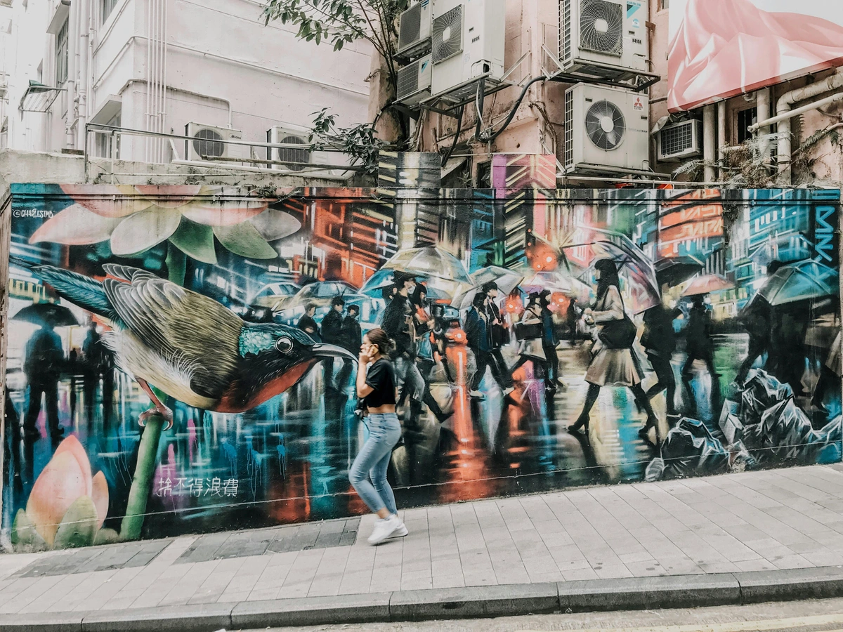 Woman admires vibrant graffiti mural showcasing public art