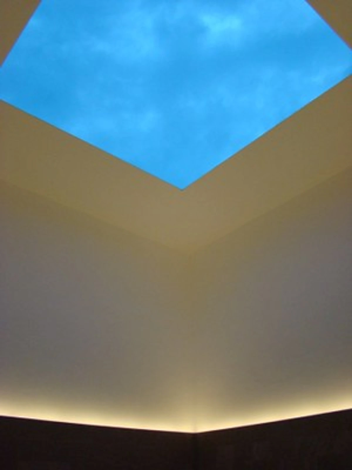 James Turrell's Blue Planet Sky installation, showcasing a celestial experience through a geometric skylight opening