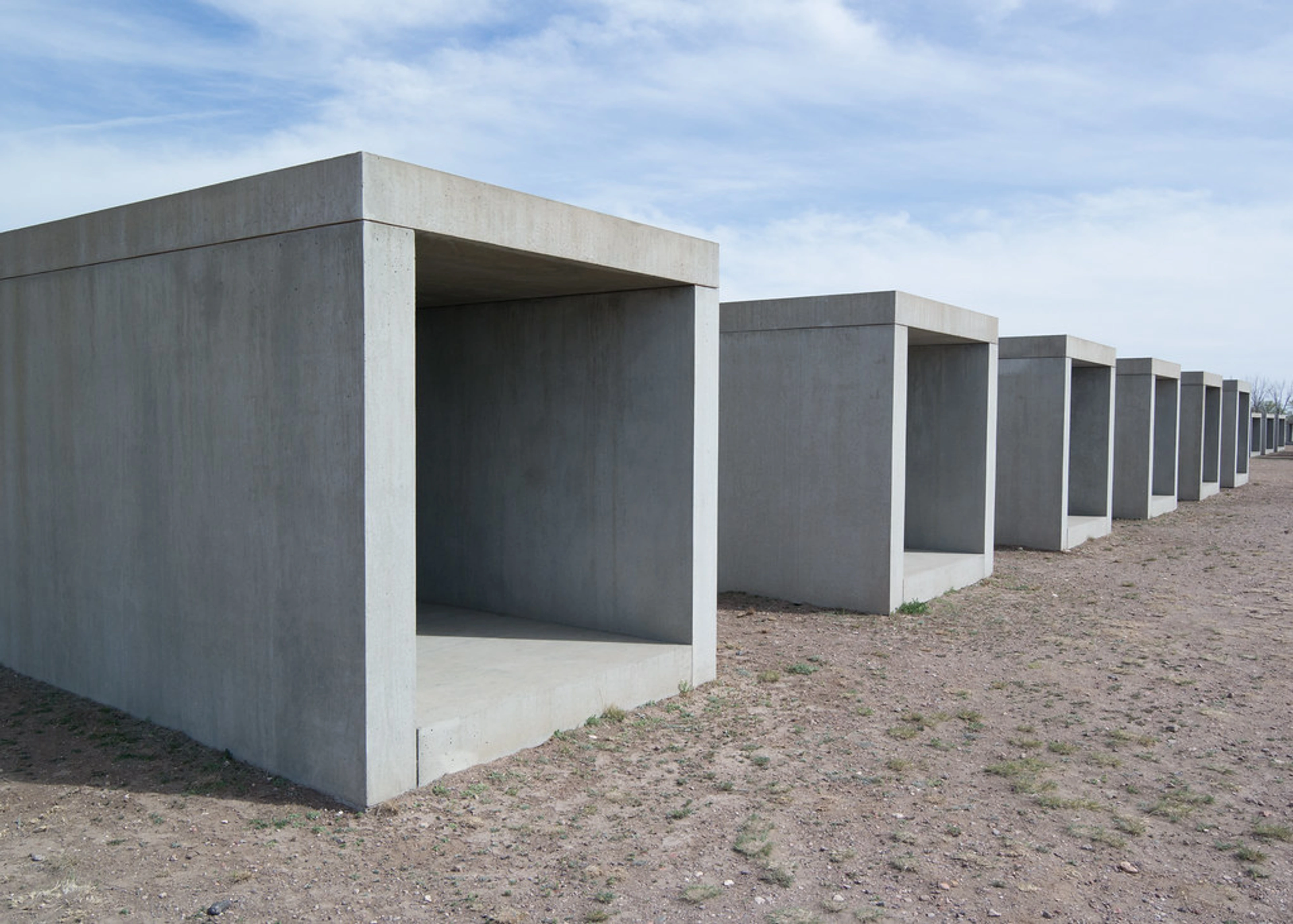 Donald Judd concrete art installations in Marfa, Texas, showcasing minimalist cubic structures in an outdoor setting.