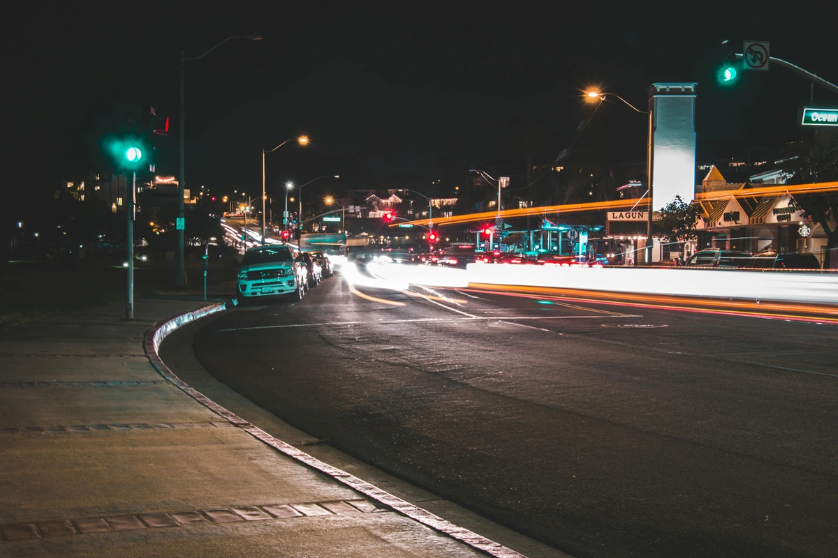 Time-lapse cityscape with car light trails and traffic lights at night, urban magical glow at night free stock photo