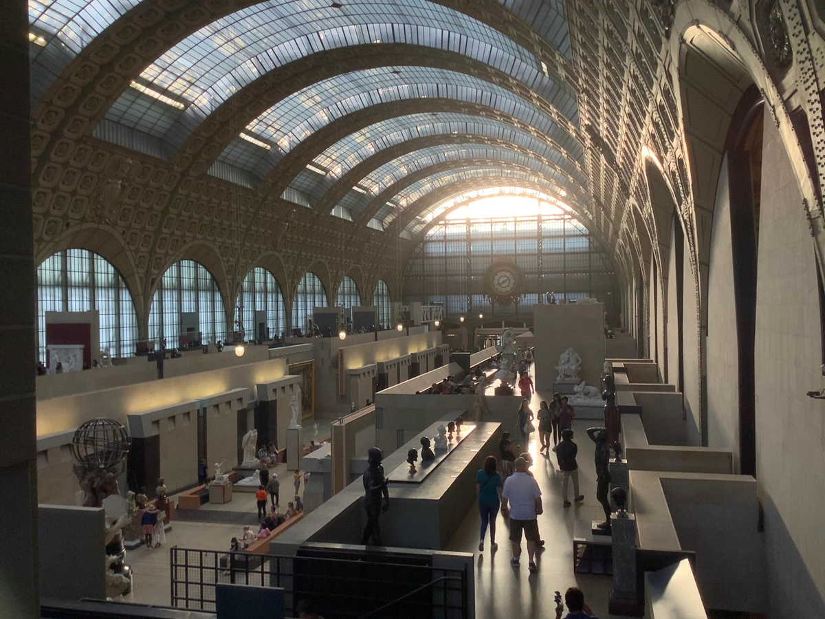 Interior of the Musée d'Orsay in Paris, featuring its grand arched glass ceiling and clock.