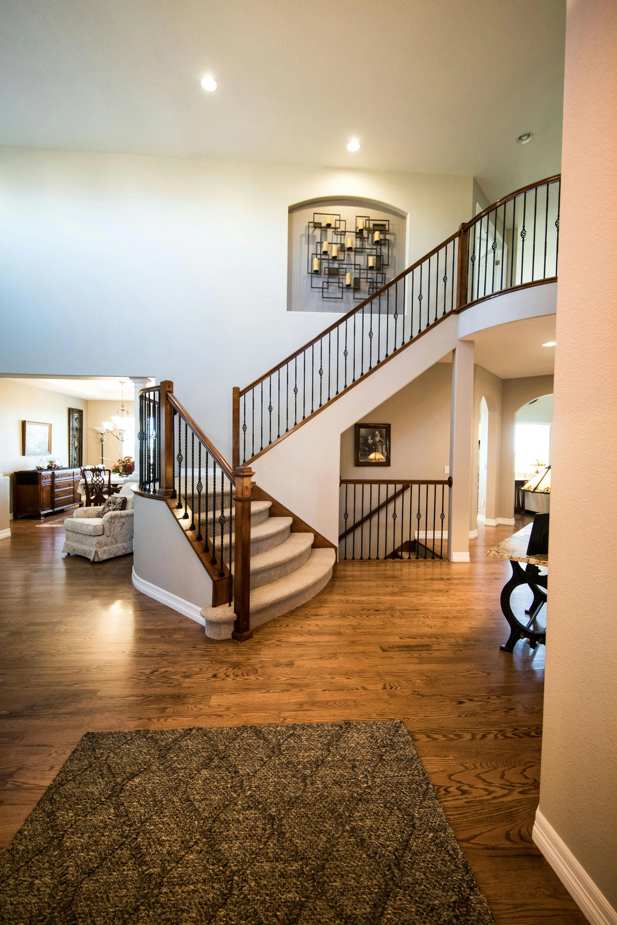 Elegant staircase with a curated gallery wall featuring framed art and decorative candles.