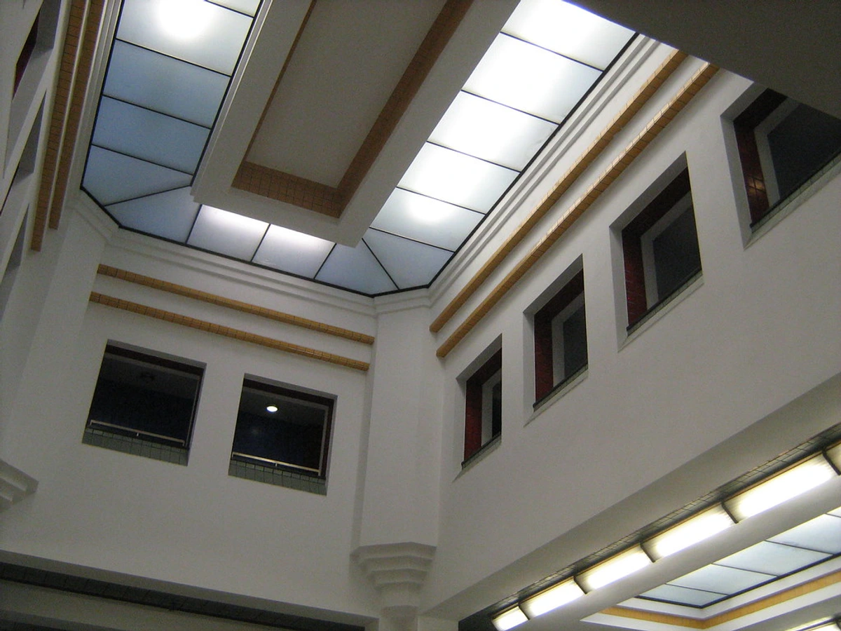 Modernist 1935 Gemeentemuseum Den Haag with Berlage architectural style, white walls and red accents, tiered façade design, skylights, Dutch heritage landmark