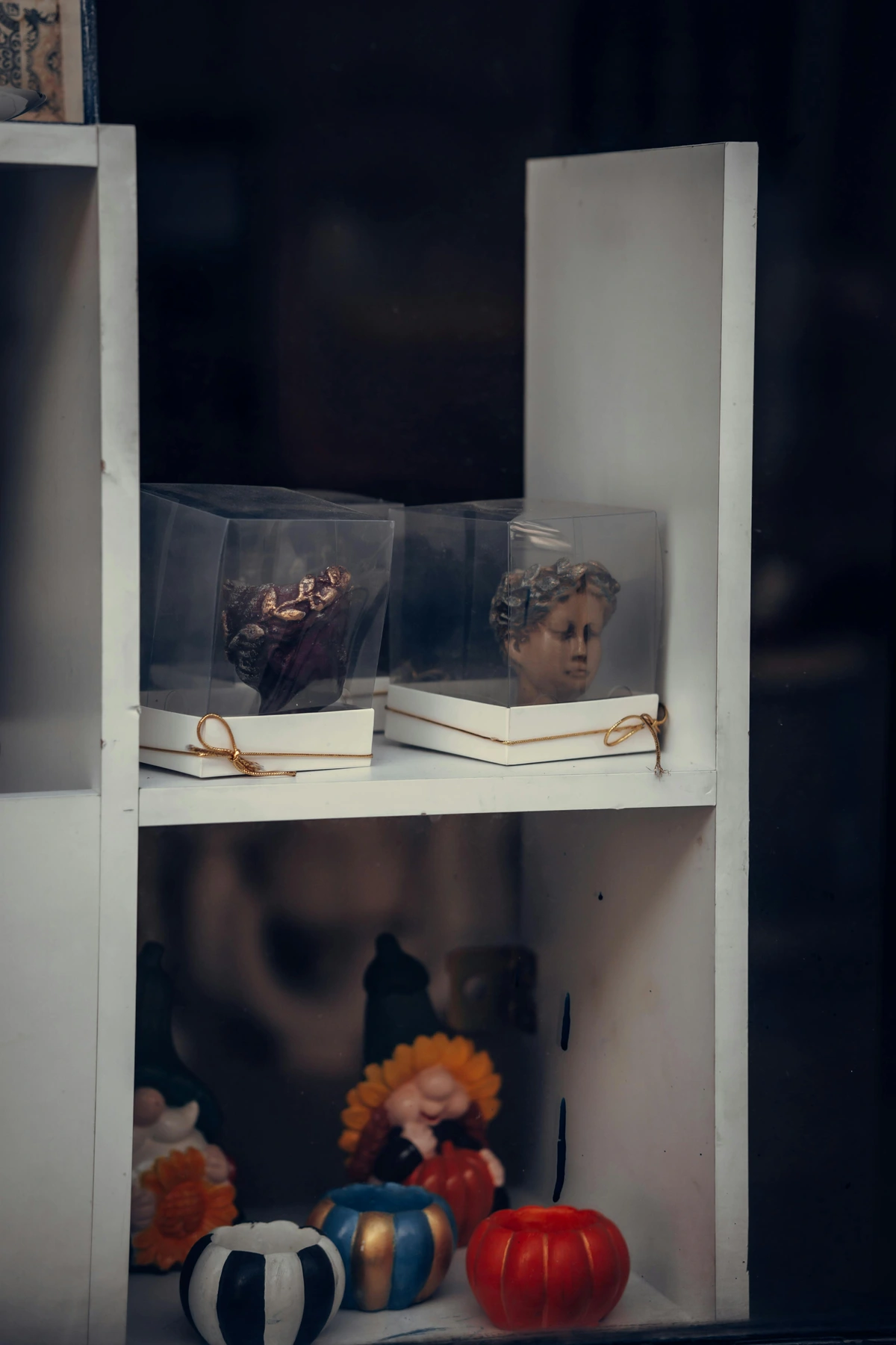 Decorative figurines displayed on a white shelf, showcasing a unique way to add charm to home decor.