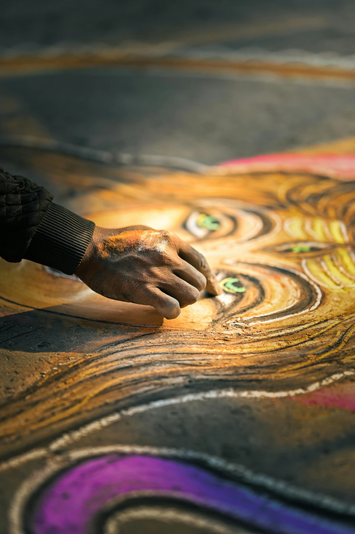 Artist's hand touching an oil painting with textured brushstrokes, highlighting creativity and craftsmanship.