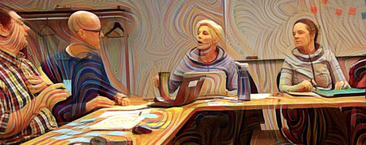 People in a meeting discussing abstract art with swirling patterns in the background.