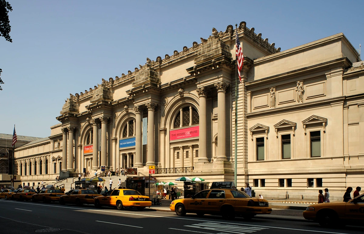 Angled view of the Metropolitan Museum of Art's main facade and street entrance.