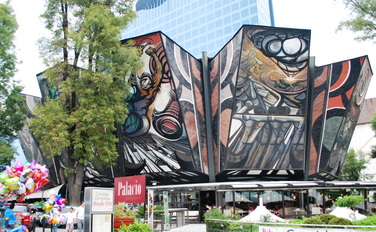 The Polyforum Siqueiros, a cultural center in Mexico City, featuring a large, colorful mural by David Alfaro Siqueiros, representing Mexican muralism and themes of social and political revolution.