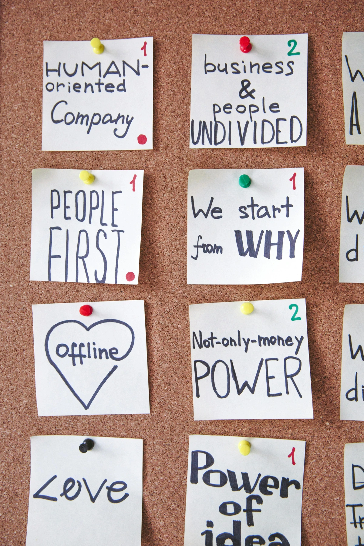 Cork board with handwritten notes about lessons learned, including 'Human-oriented Company', 'People First', 'Offline', 'Love', 'Business & People Undivided', 'We start from WHY', 'Not-only-money POWER', and 'Power of idea'.