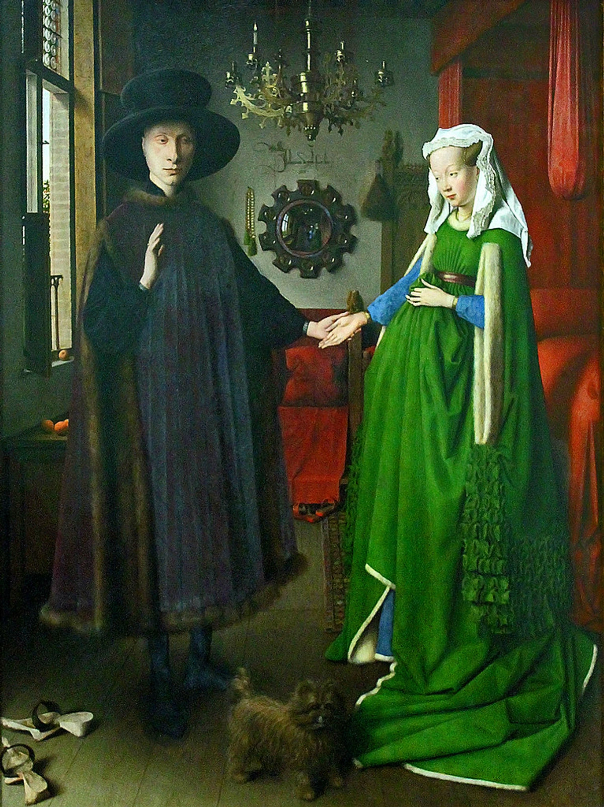 Symbolism in Jan van Eyck's Arnolfini Portrait, showing Giovanni Arnolfini and his wife in a domestic interior.