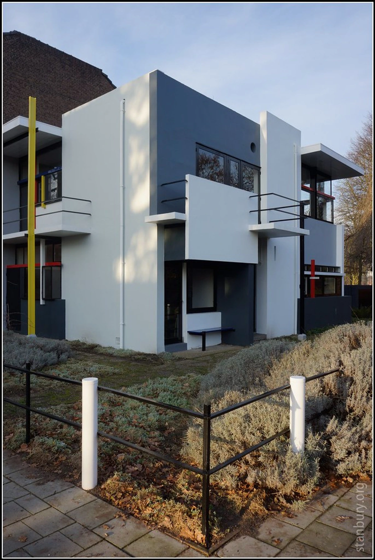 The Rietveld Schröder House, a De Stijl masterpiece by Gerrit Rietveld, showcasing its iconic asymmetrical facade with primary color accents and geometric forms.