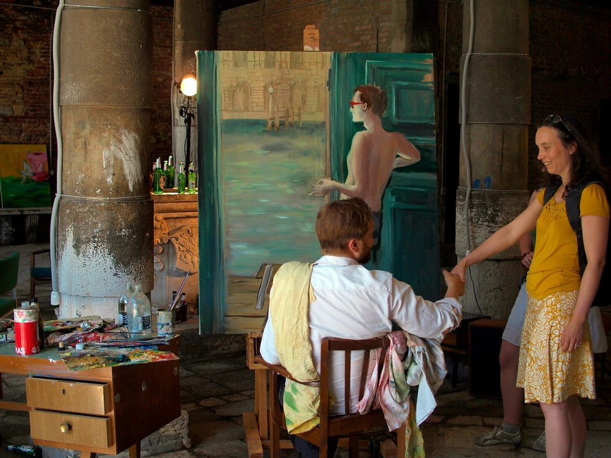 Artist Ragnar Kjartansson's "The End" installation at the Venice Biennale, featuring a painting of a man in front of a doorway and two people interacting.