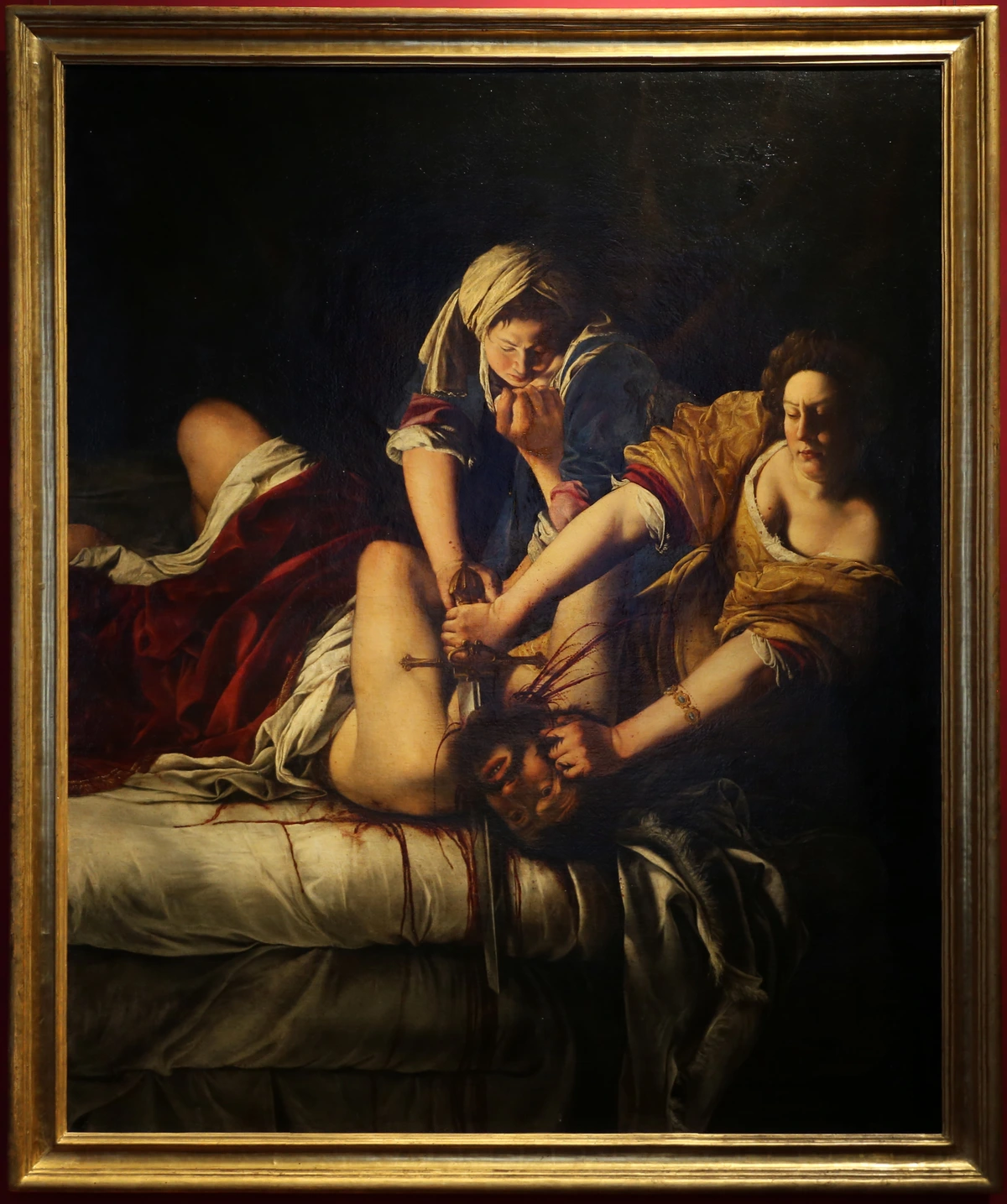 Judith Beheading Holofernes by Artemisia Gentileschi, a dramatic Baroque painting depicting the biblical heroine Judith beheading the Assyrian general Holofernes with the help of her maidservant Abra.