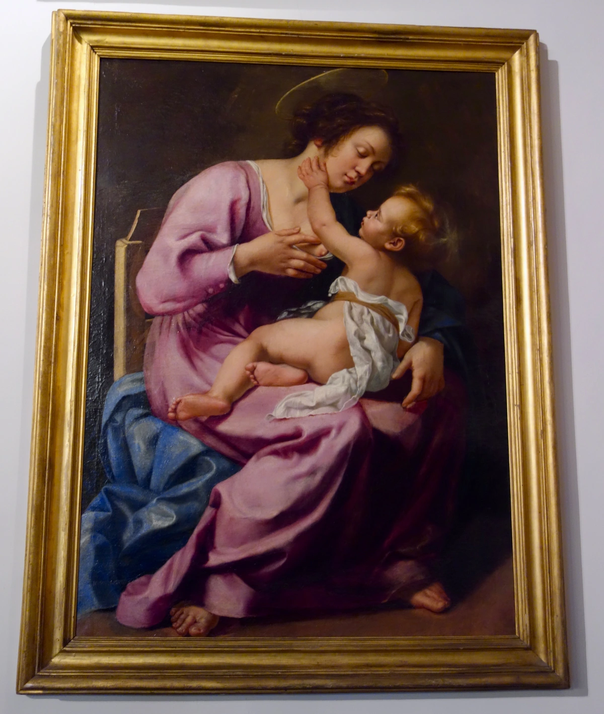 Artemisia Gentileschi's Madonna and Child painting from 1613, depicting the Virgin Mary breastfeeding the infant Jesus.