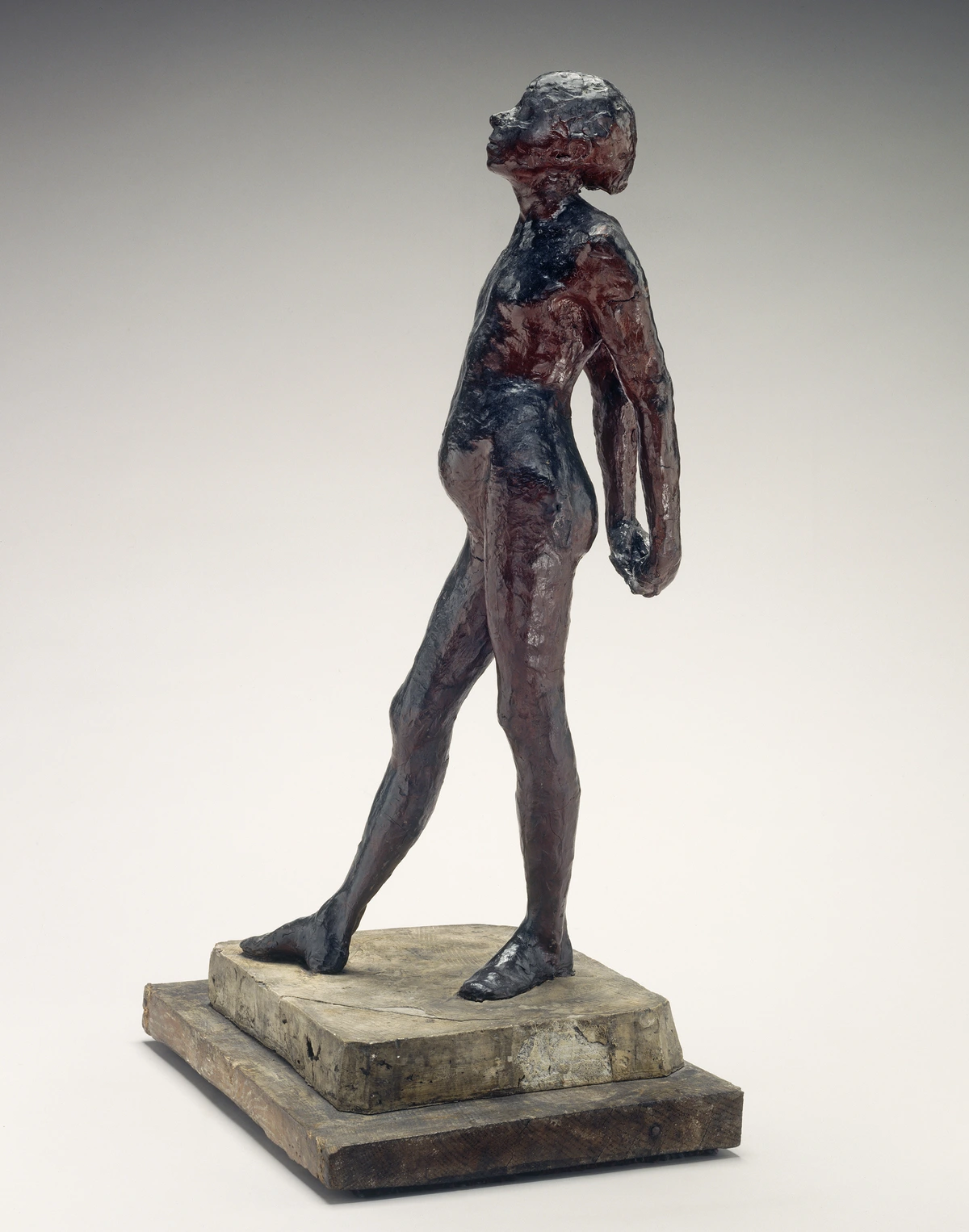 Edgar Degas' bronze sculpture 'Little Dancer Aged Fourteen', a study of a young ballet dancer in a nude pose on a wooden base.