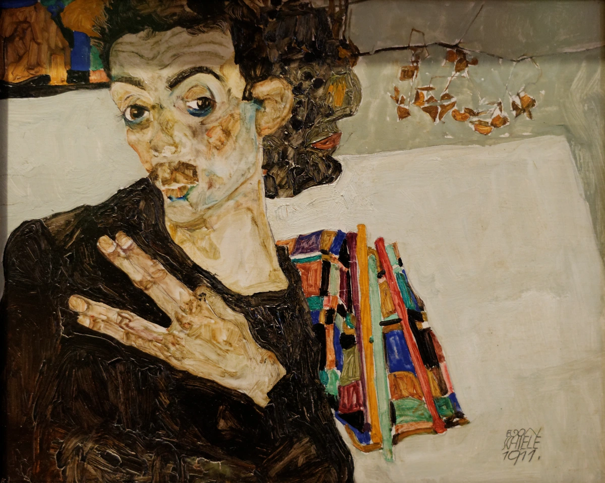 Egon Schiele's 1911 self-portrait, showcasing his distinctive style and intense gaze. | Zelfportret van Egon Schiele uit 1911, met zijn kenmerkende stijl en intense blik.