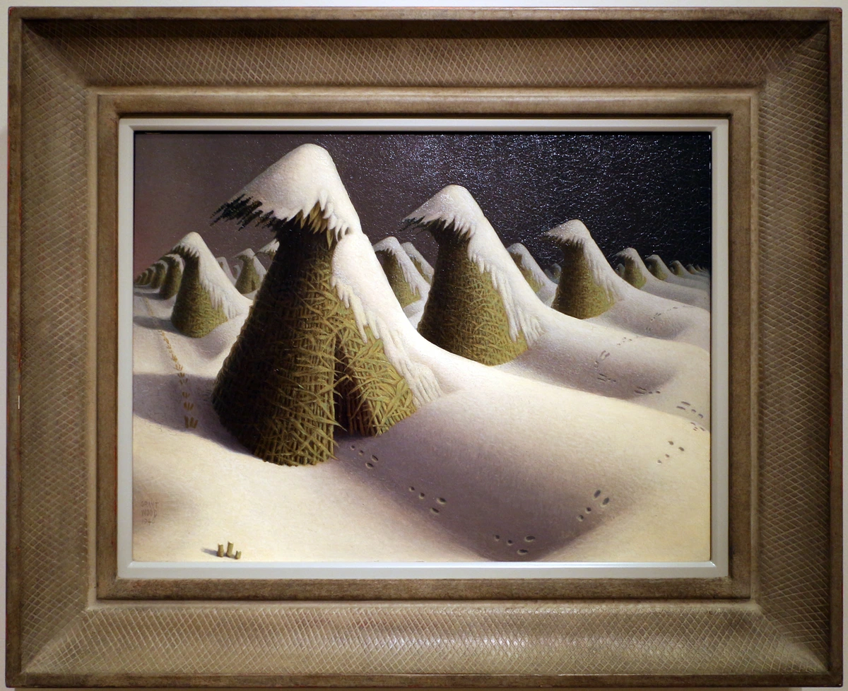 Grant Wood's painting 'January' depicting snow-covered haystacks in a winter landscape, 1940-41.