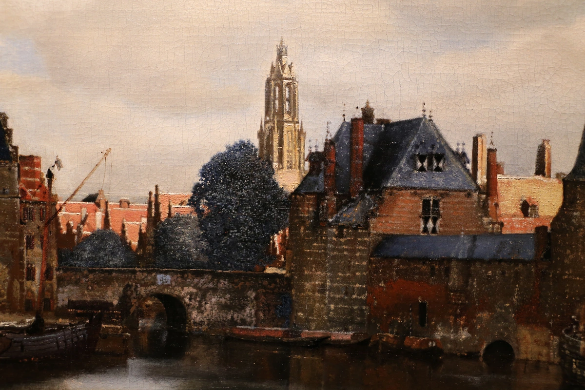 Johannes Vermeer's View of Delft, a 17th-century cityscape featuring a canal, bridge, and prominent church tower.