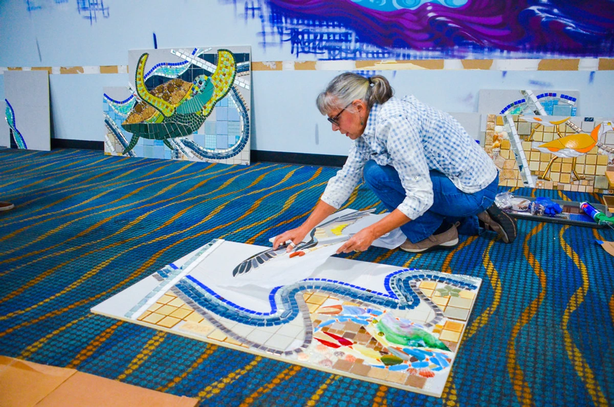 JAXPORT executives visit progress of a unique art installation in a museum setting. The image highlights corporate collaboration with cultural institutions and showcases the development of an art project.